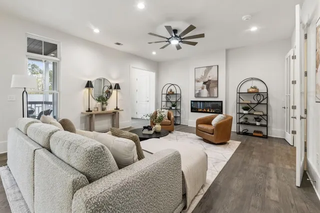 a living room with furniture and a chandelier