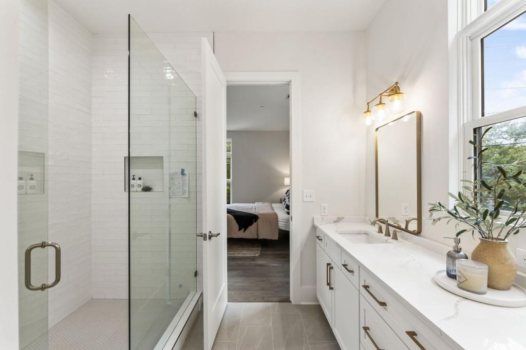 12455 Broadwell Road, Unit 201 Milton, GA 30004 - Photo 32 of 38 a en suite bathroom with a double vanity sink and a mirror