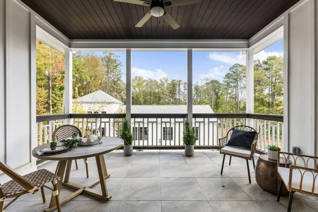 a living room with a floor to ceiling windows and a table