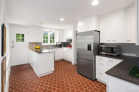 a kitchen with a refrigerator sink and microwave