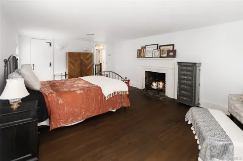 a bedroom with a bed and a fireplace