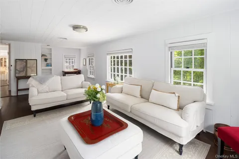 a living room with furniture a rug and a window