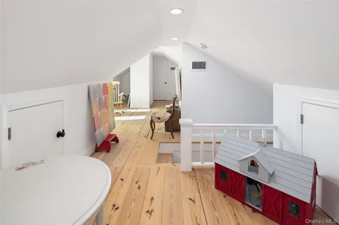 a playing room with furniture and wooden floor