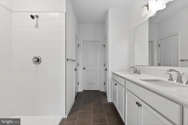a bathroom with a double vanity sink and mirror