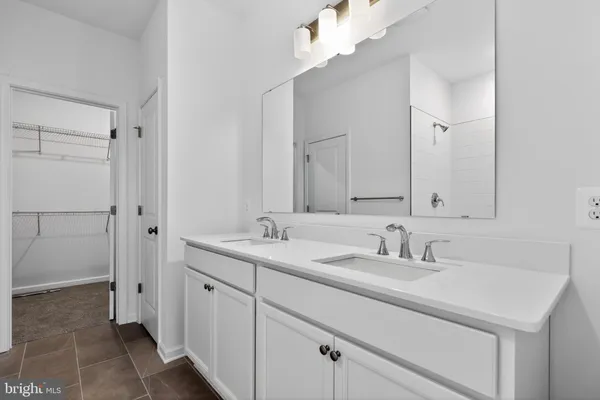 a bathroom with a sink double vanity and a mirror