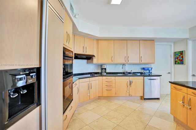 a view of a hallway with wooden floor and a large window