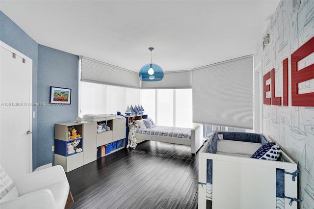 a view of a dining room with furniture a chandelier and wooden floor