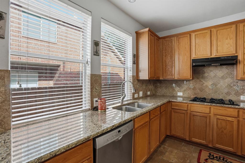 5913 Independence Court Rowlett, TX 75089 - Photo 11 of 27 a kitchen with stainless steel appliances granite countertop a sink and cabinets