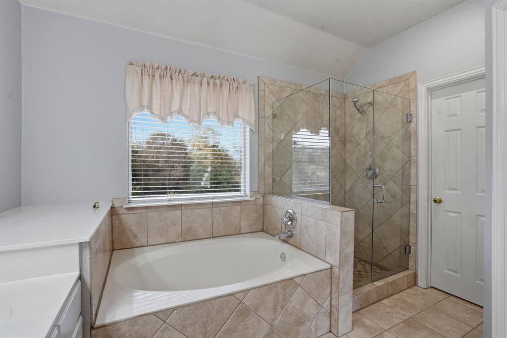 5913 Independence Court Rowlett, TX 75089 - Photo 21 of 27 a bathroom with a tub shower and sink
