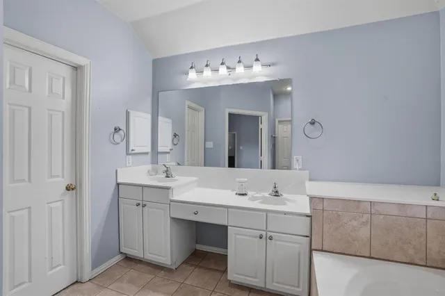 a bathroom with a sink vanity and mirror