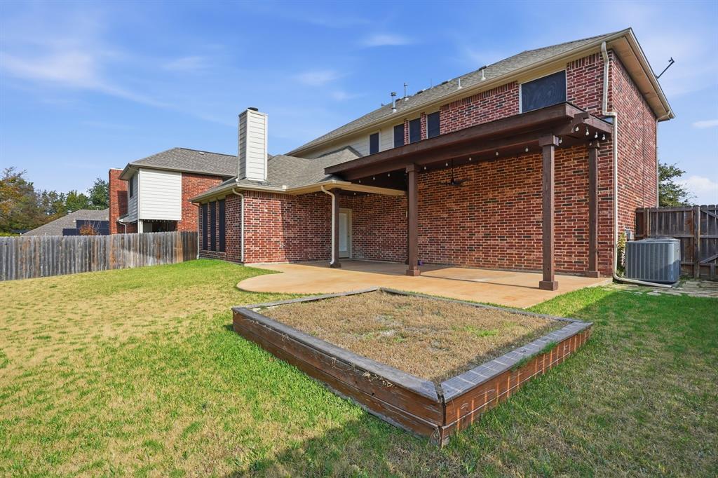 5913 Independence Court Rowlett, TX 75089 - Photo 23 of 27 a front view of a house with garden