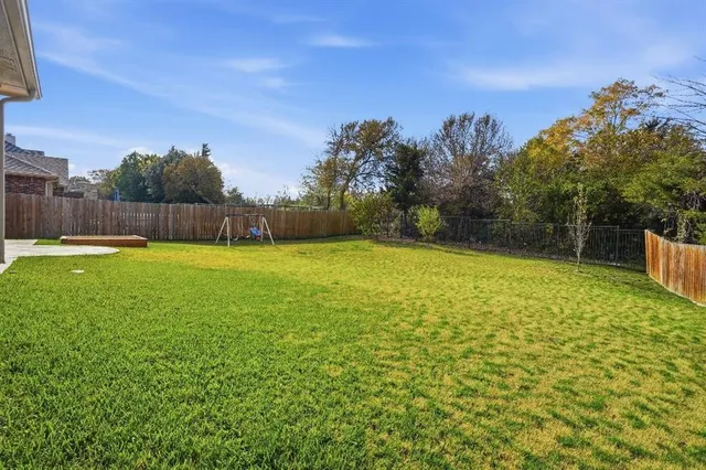 a view of a yard with a house in the background