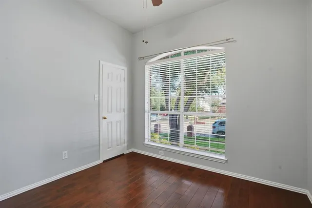 a view of a room with wooden floor and windows