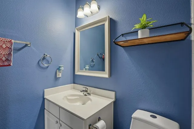 a bathroom with a sink a toilet and a mirror