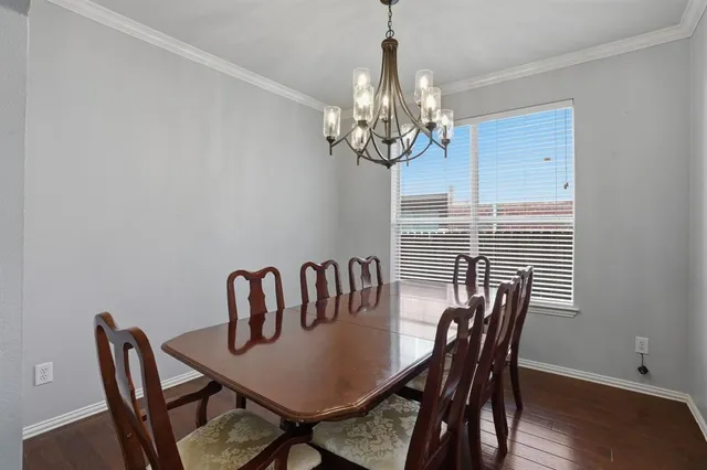 a view of a dining room with furniture wooden floor and chandelier