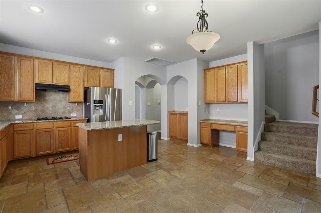 5913 Independence Court Rowlett, TX 75089 - Photo 10 of 27 a kitchen with stainless steel appliances granite countertop a refrigerator a sink dishwasher stove and oven