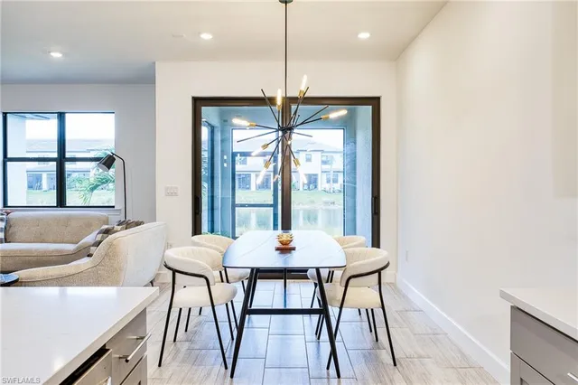 a kitchen with a sink counter top space and living room area