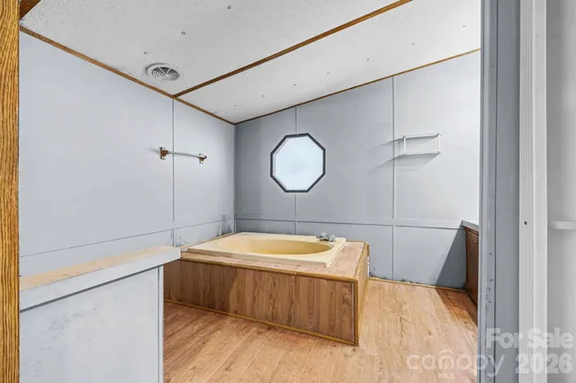 a bedroom with a bed and a mirror