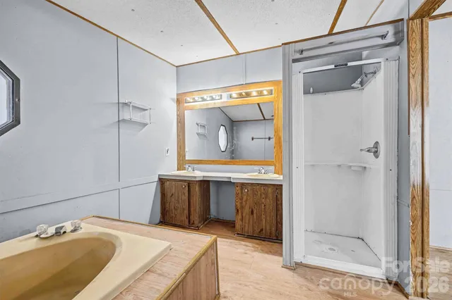 a bathroom with a granite countertop sink mirror and shower