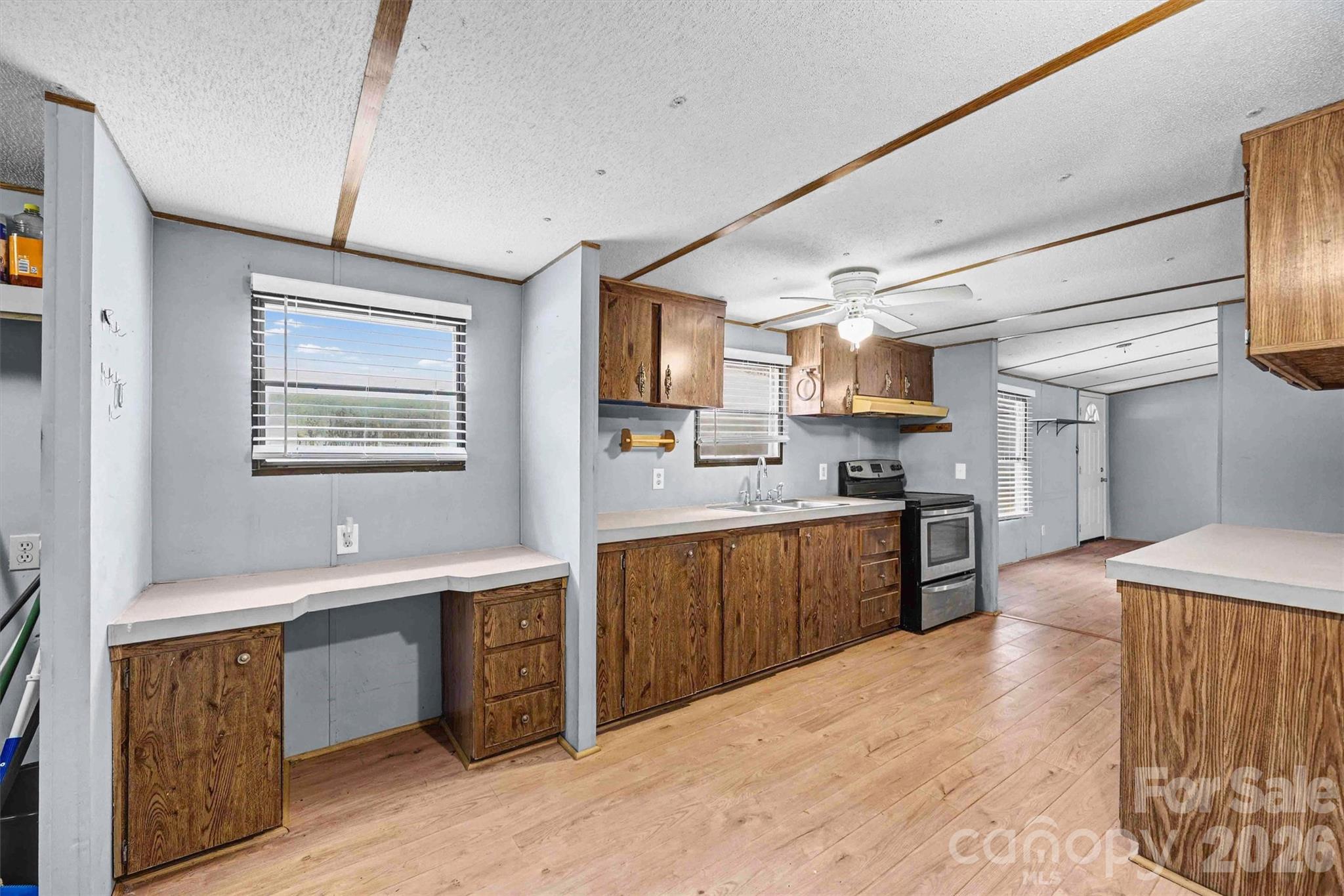 1612 Honeysuckle Pond Road Rock Hill, SC 29732 - Photo 9 of 26 a large kitchen with stainless steel appliances kitchen island granite countertop a sink and wooden cabinets