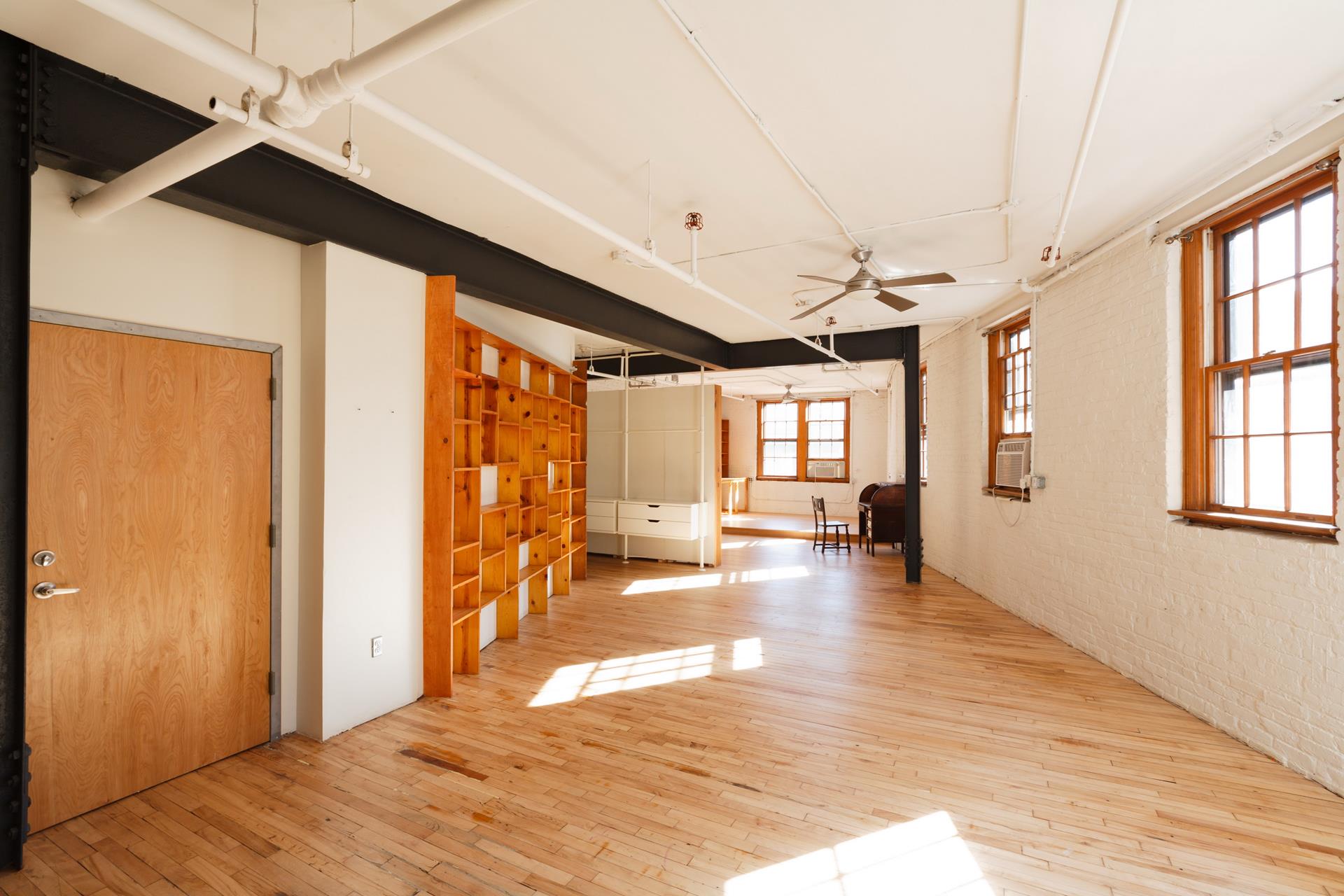 210 Spring Street, Unit 5 Manhattan, NY 10012 - Photo 10 of 13 a view interior of a house wooden floor and windows