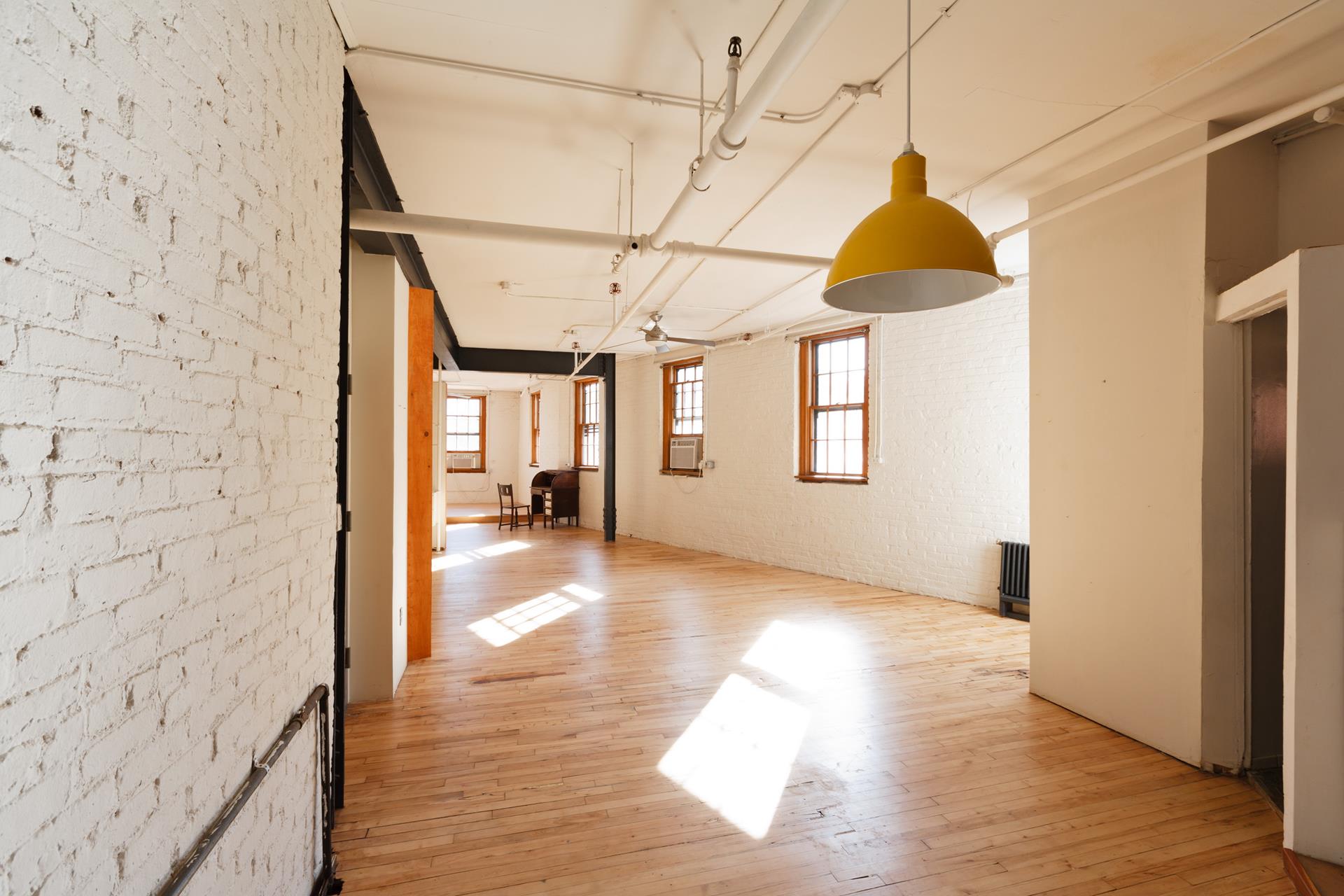 210 Spring Street, Unit 5 Manhattan, NY 10012 - Photo 11 of 13 a view of a bathroom with a sink and a window