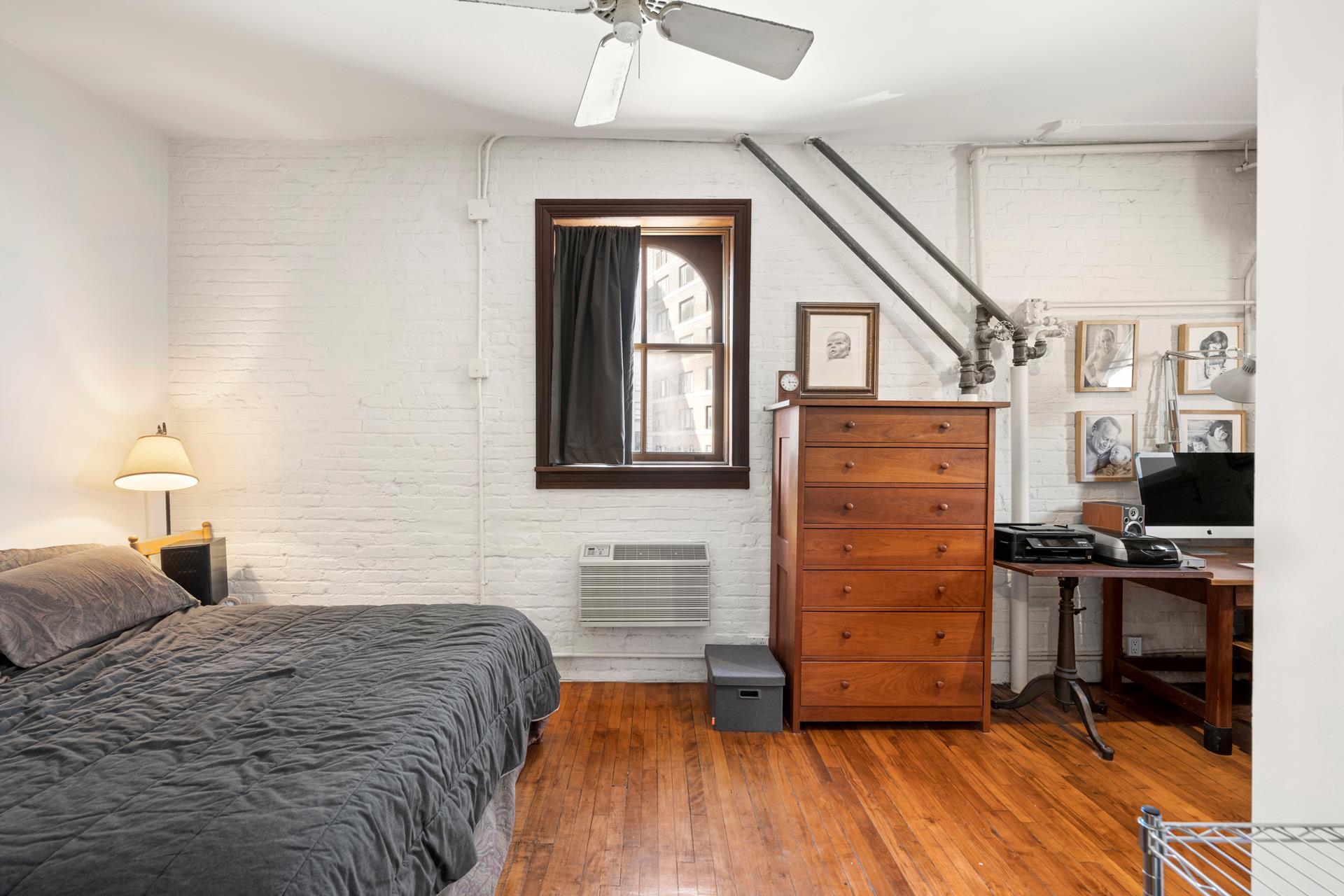 210 Spring Street, Unit 5 Manhattan, NY 10012 - Photo 4 of 13 a bedroom with a bed and a dresser