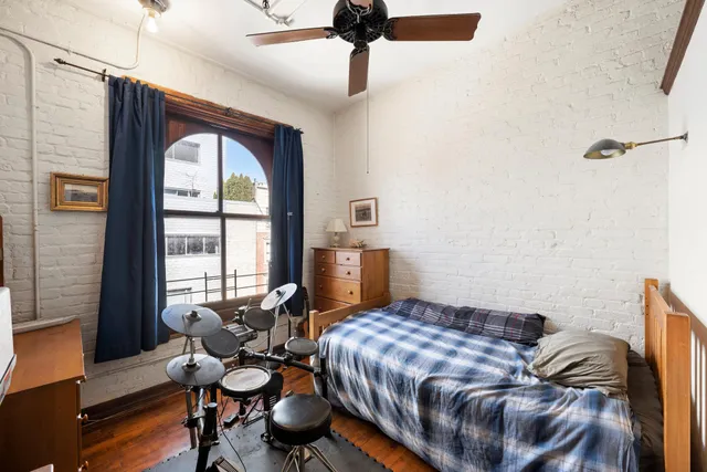 a bedroom with a bed and a dresser