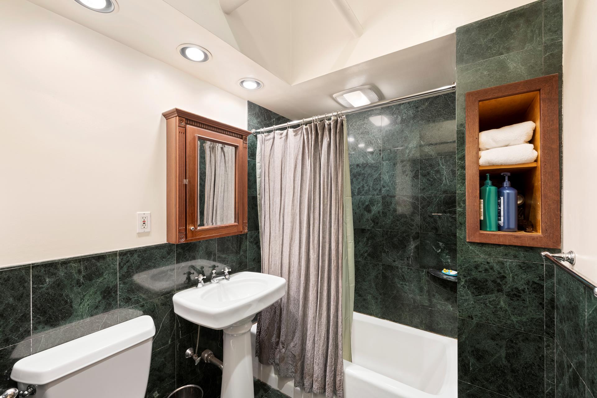 210 Spring Street, Unit 5 Manhattan, NY 10012 - Photo 6 of 13 a bathroom with a sink a toilet and shower