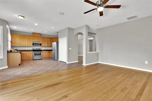 a view of a kitchen with a sink stainless steel appliances and cabinets