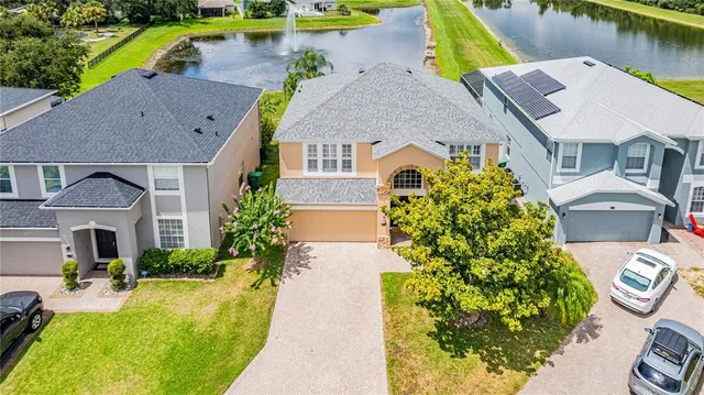 an aerial view of a house with swimming pool and porch