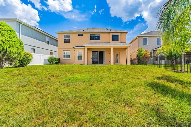 a big house with a big yard and large trees