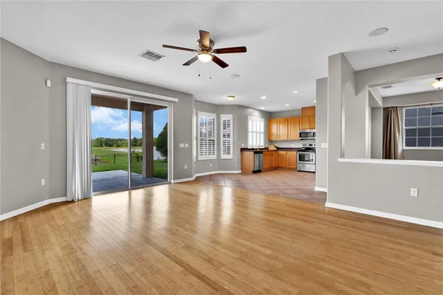 a view of a livingroom with furniture hardwood floor and a large window