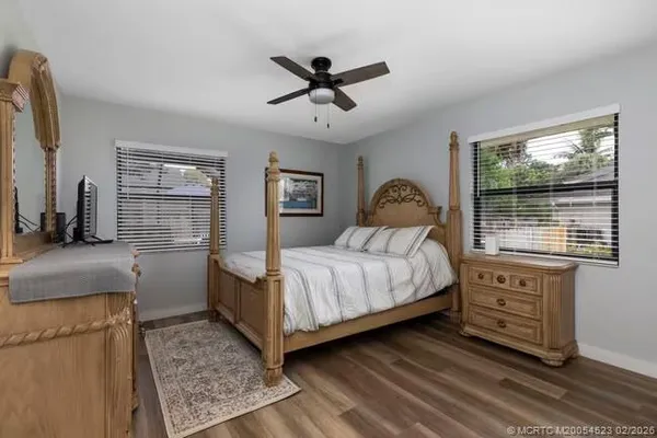 a bedroom with a bed and wooden floor