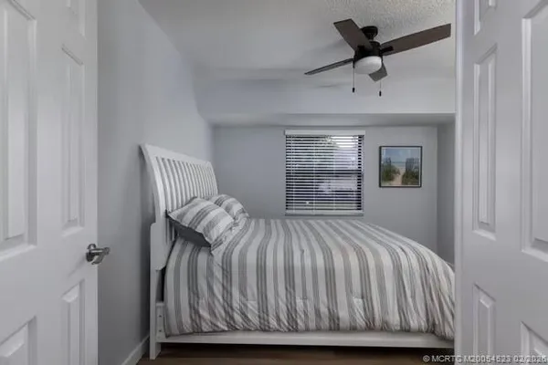 a bedroom with a bed and a chandelier