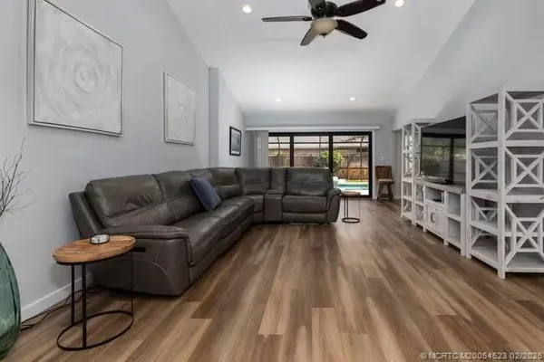 a living room with furniture or couch and a wooden floor