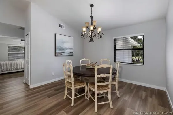 a view of a dining room with furniture wooden floor and chandelier