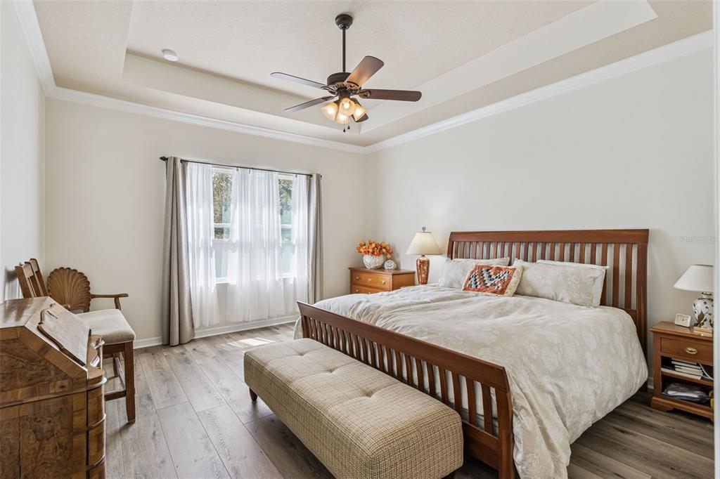 31518 Bearded Oak Drive Wesley Chapel, FL 33543 - Photo 21 of 56 a bedroom with a bed and wooden floor
