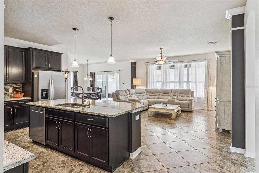 31518 Bearded Oak Drive Wesley Chapel, FL 33543 - Photo 3 of 56 a kitchen with a sink stove and cabinets