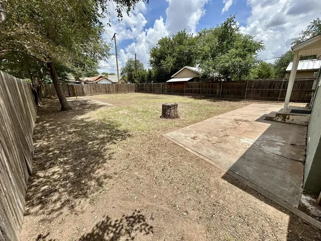 a view of a backyard with sitting area