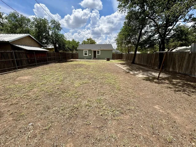 a front view of house with a garden