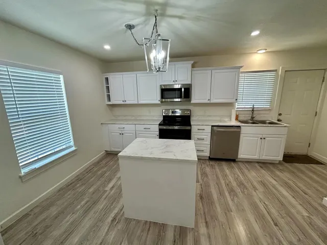 a kitchen with cabinets a sink and dishwasher