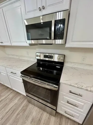 a kitchen with a stove and a microwave