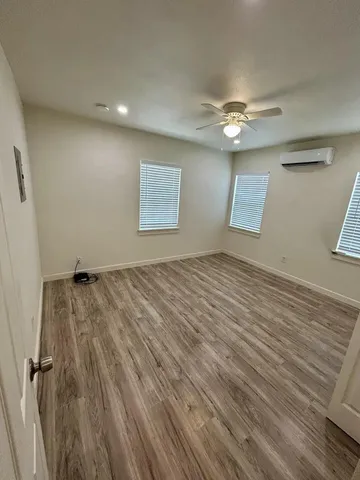 a view of a livingroom with wooden floor and a ceiling fan