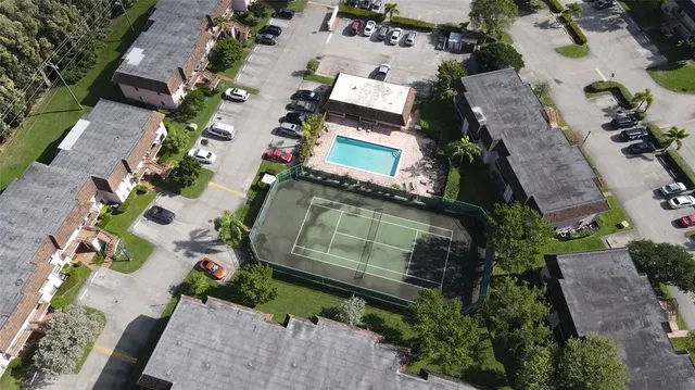 an aerial view of a house with a yard