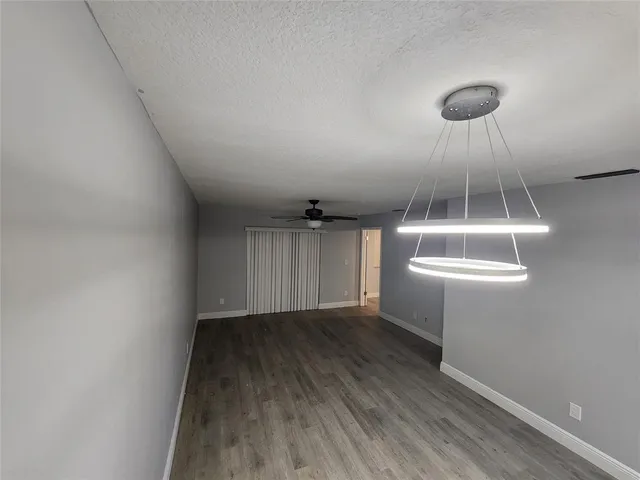 a view of a room with wooden floor and white walls