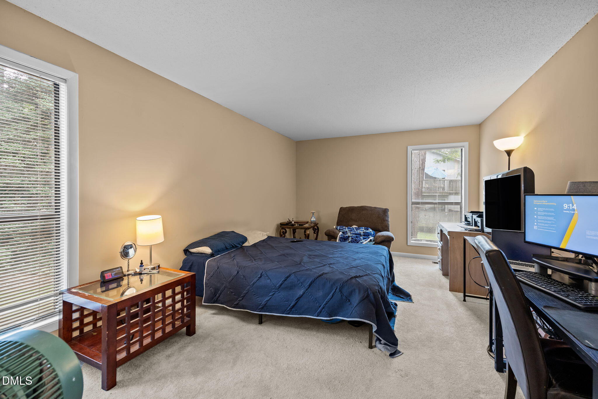 5816 Pointer Drive, Unit 102 Raleigh, NC 27609 - Photo 17 of 25 a spacious bedroom with a bed and a flat screen tv