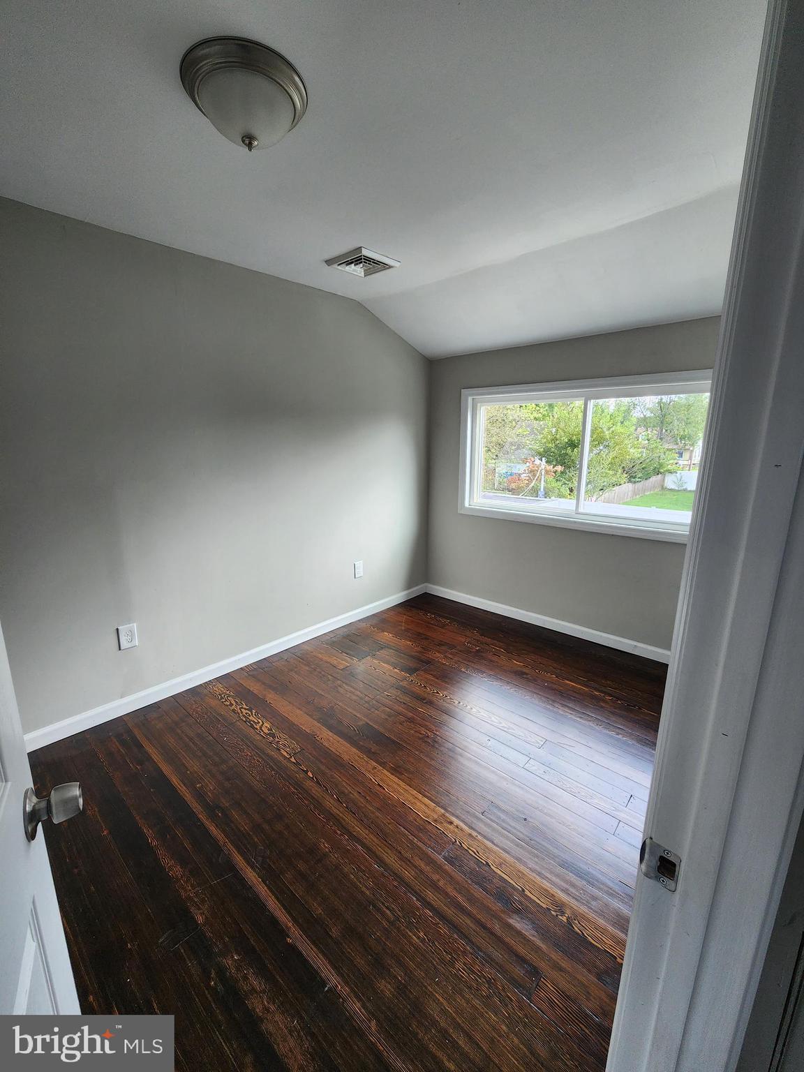 10 Webster Avenue Stratford, NJ 08084 - Photo 12 of 20 an empty room with wooden floor and windows