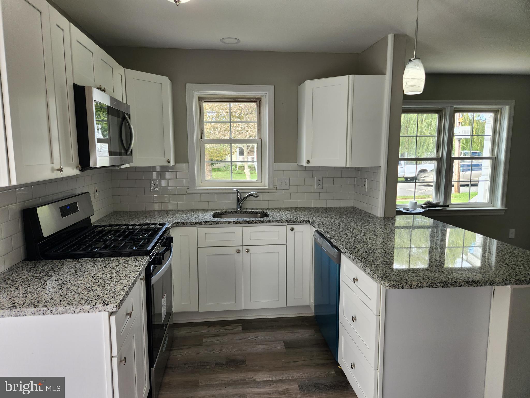 10 Webster Avenue Stratford, NJ 08084 - Photo 15 of 20 a kitchen with granite countertop stainless steel appliances window a sink and a stove