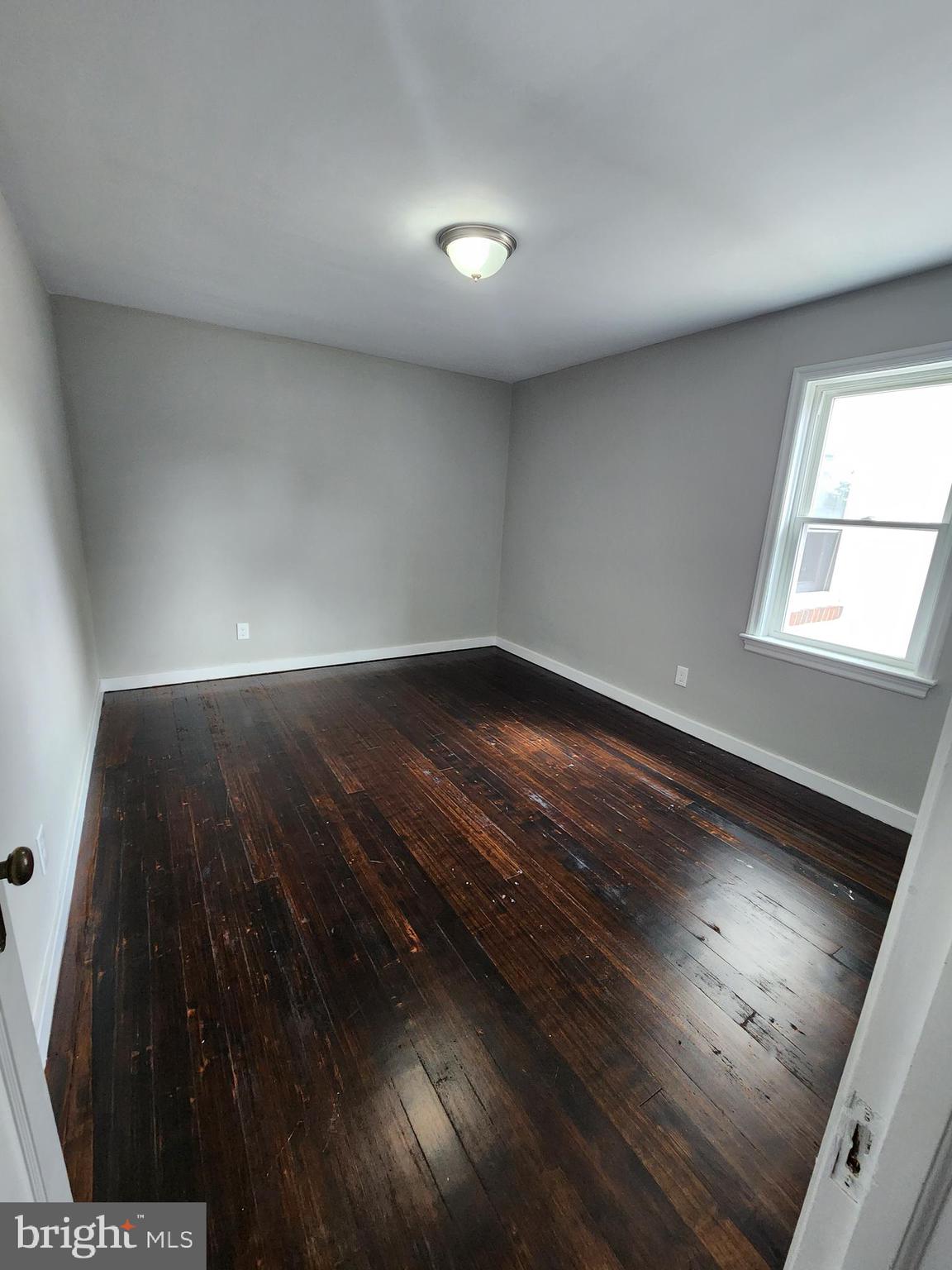 10 Webster Avenue Stratford, NJ 08084 - Photo 4 of 20 a view of empty room with wooden floor and fan